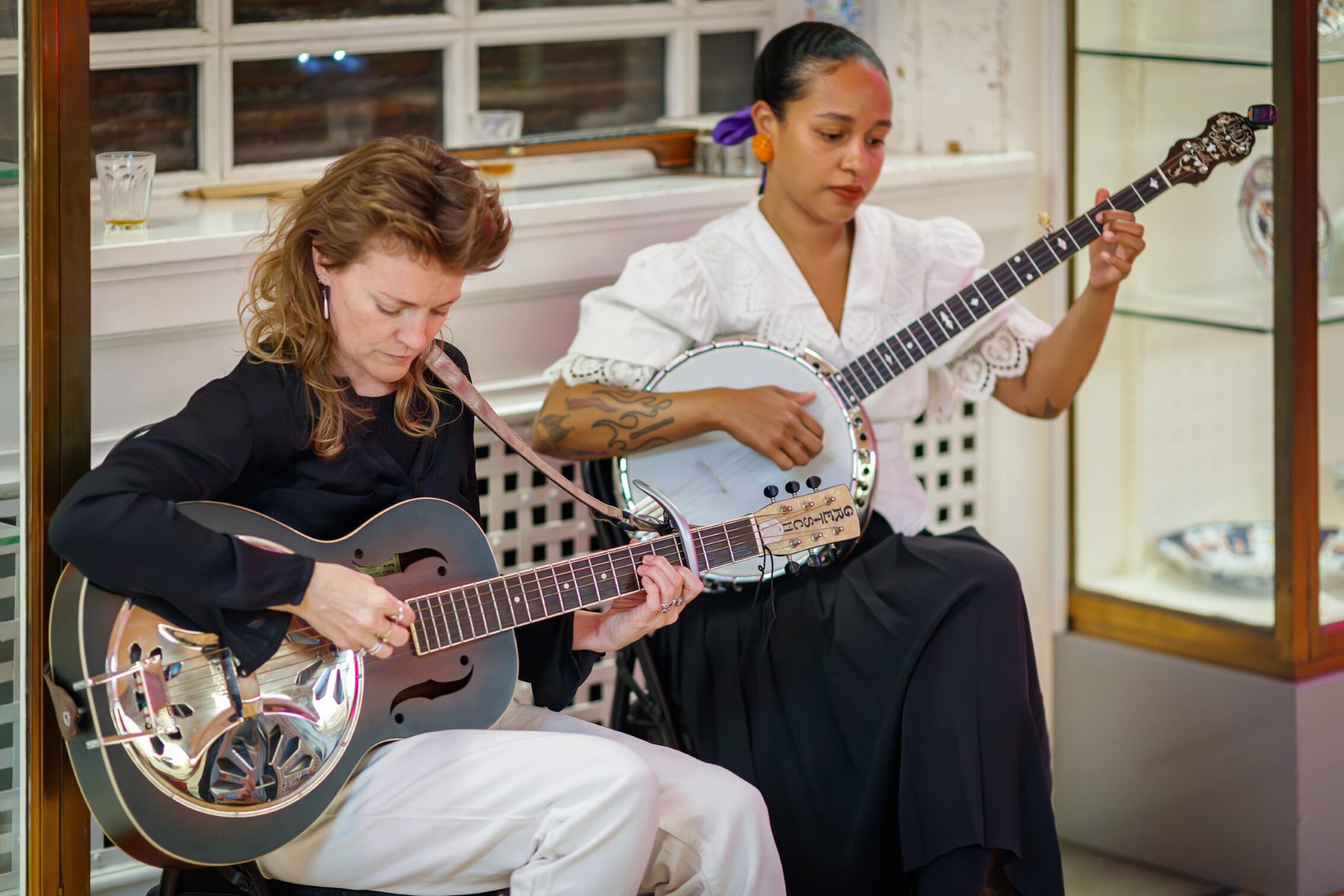 Folk duo The Pegwells playing a banjo and a guitar