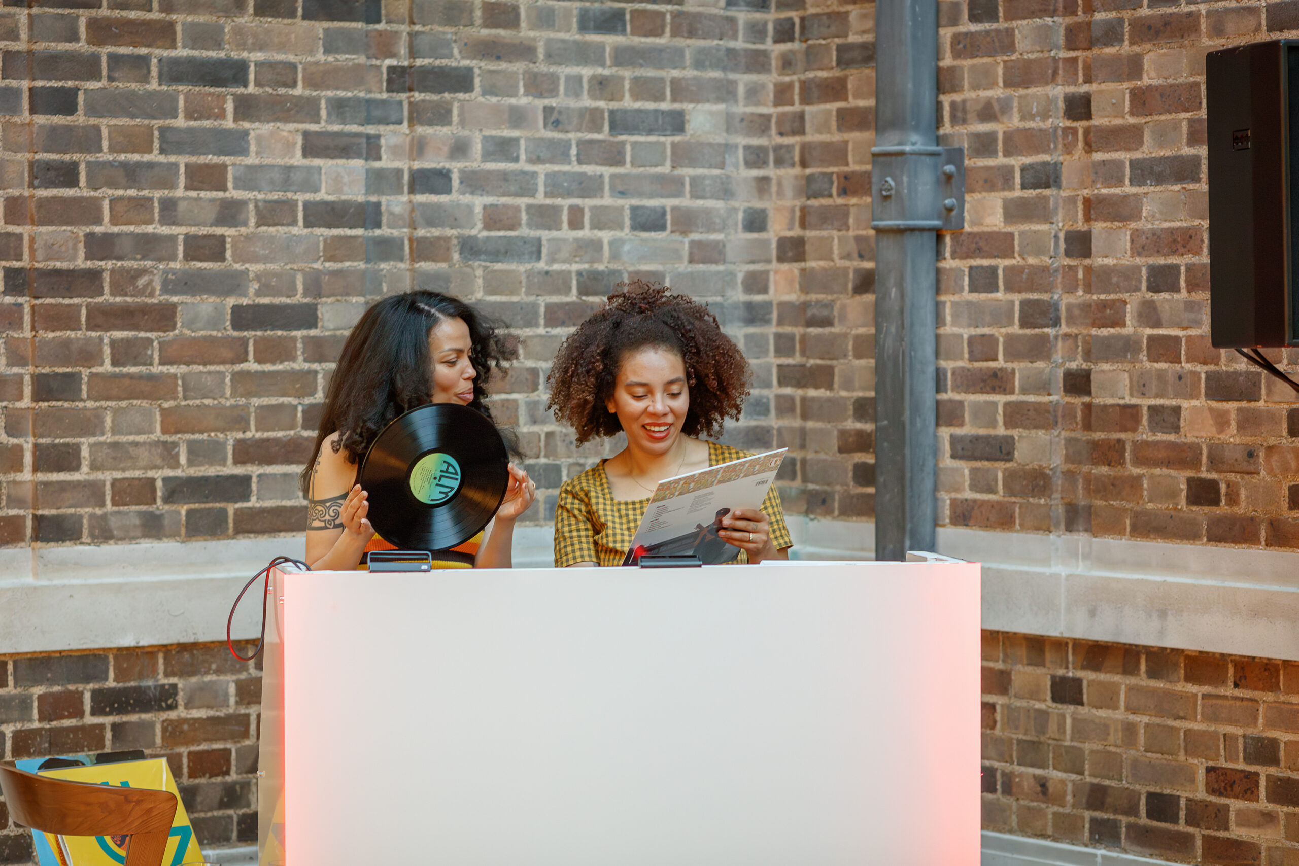 Two young female DJ's of colour playing a set at the museum