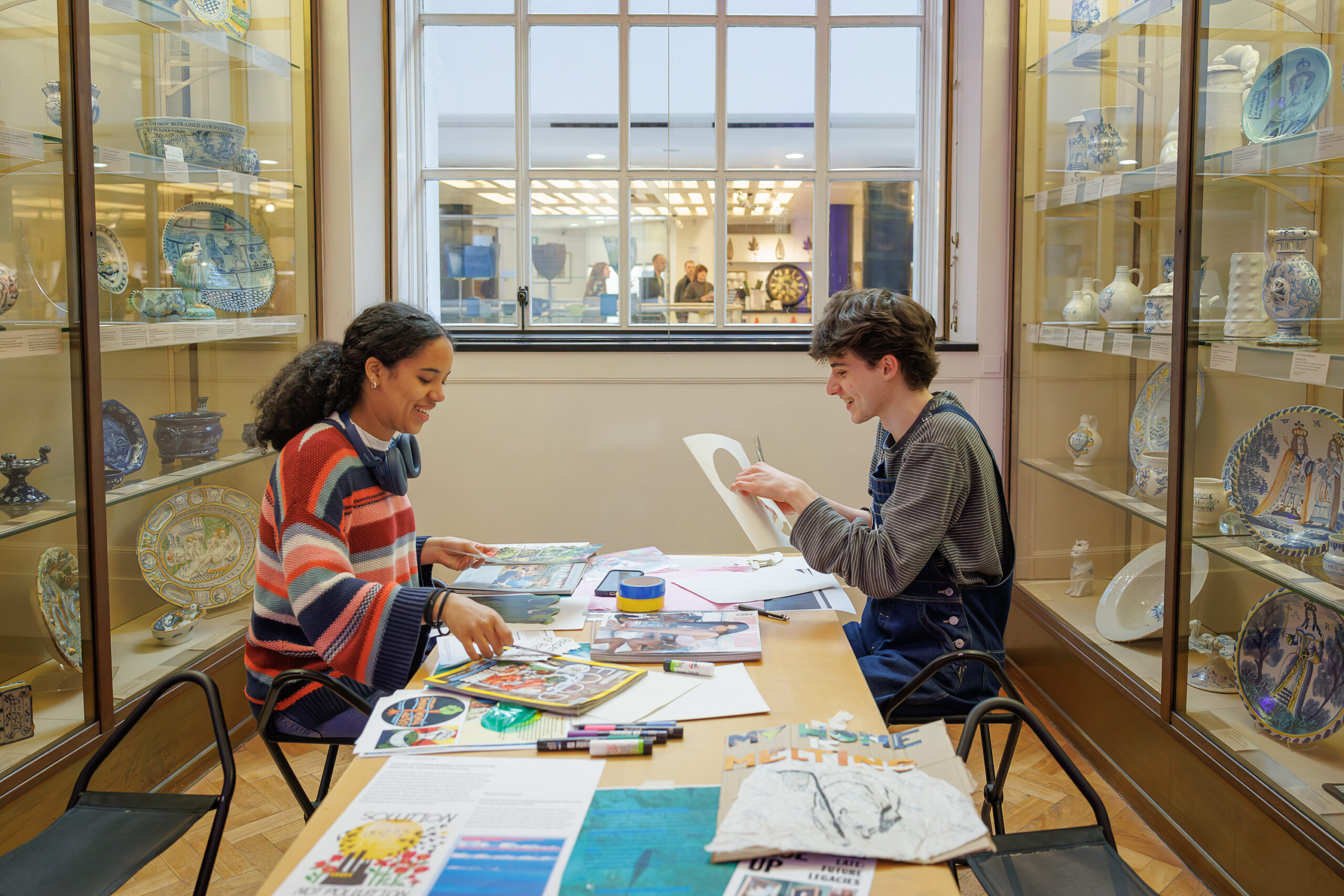 Two people collaging.