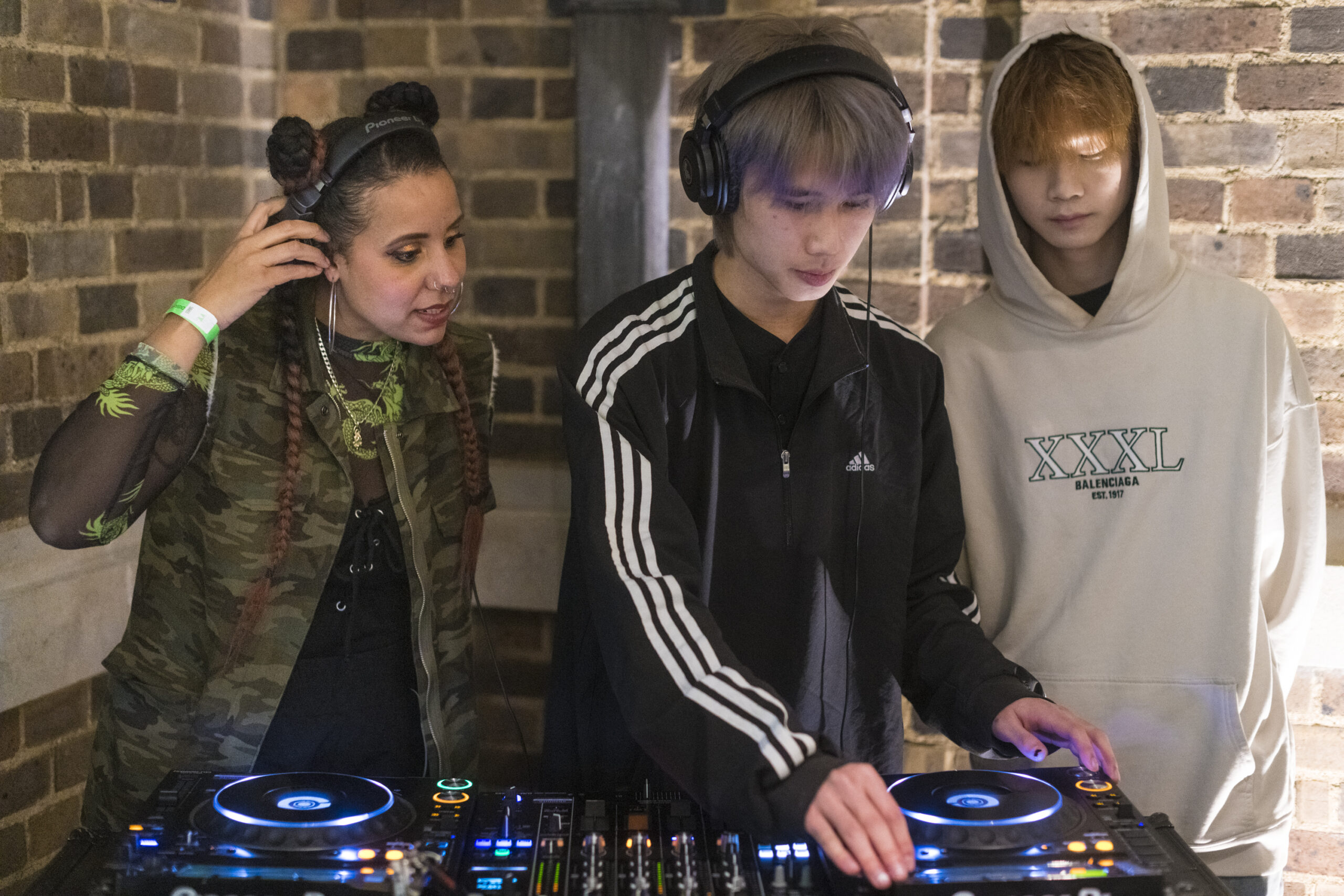 Three young people of colour in a gallery exhibition