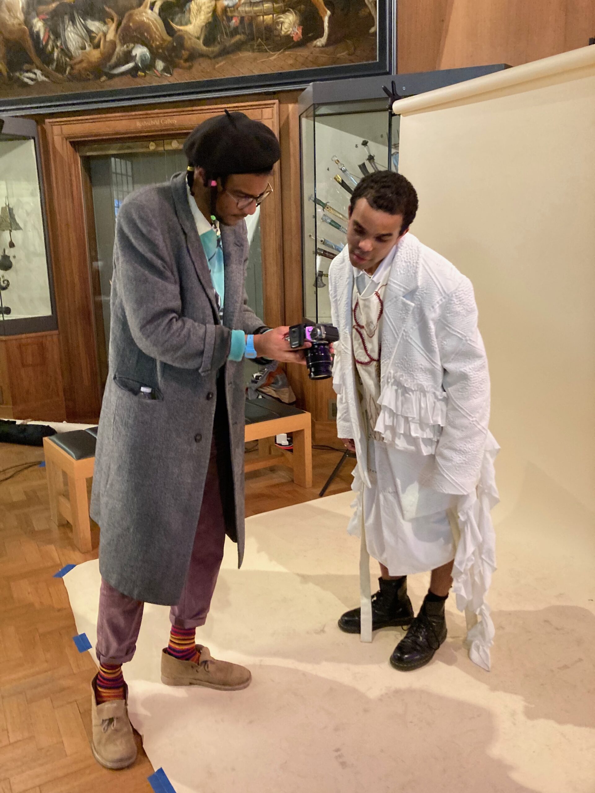 Two young men reviewing an image on a camera