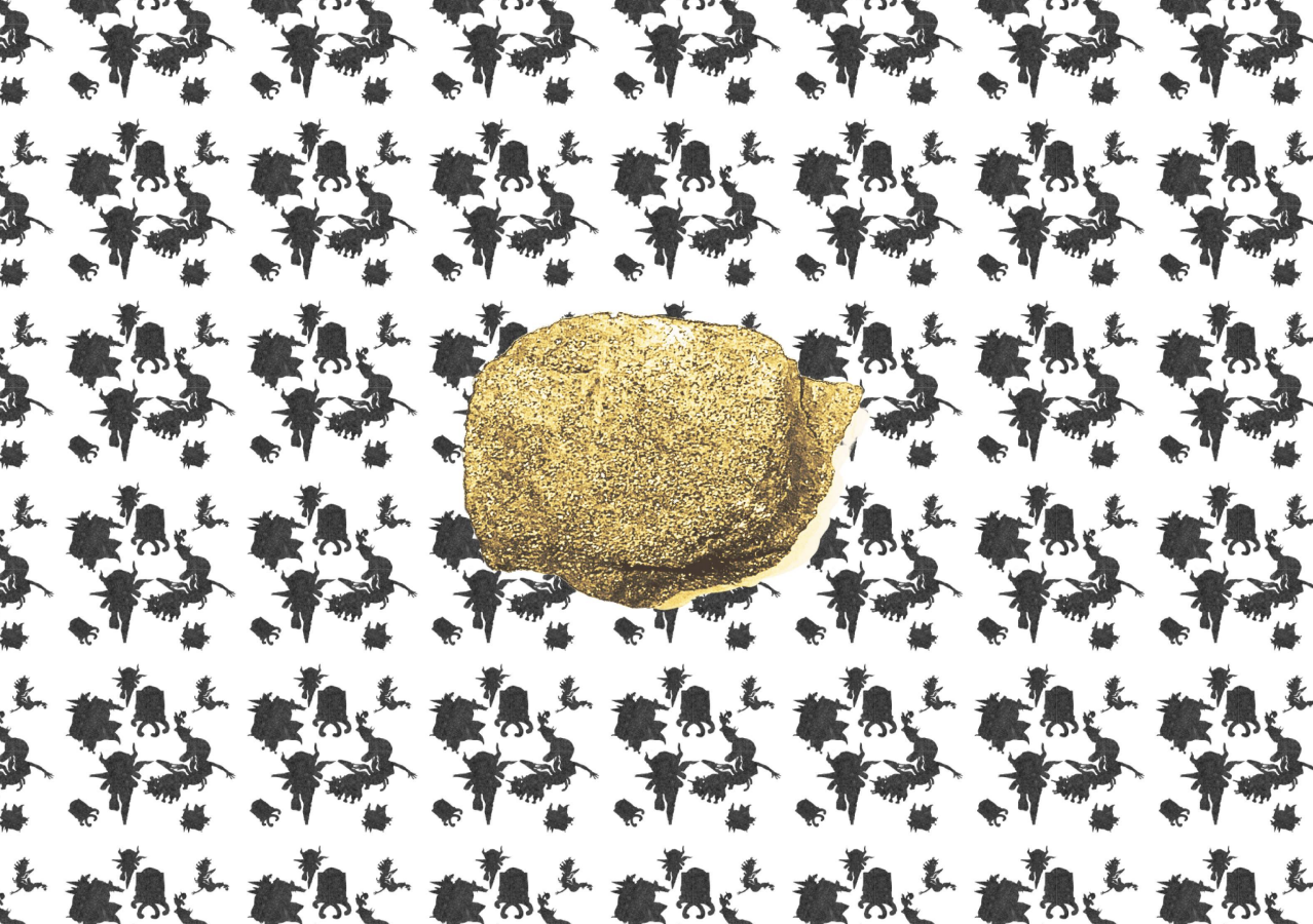A lump of coal coated in gold dust on a black and white botanical motif background